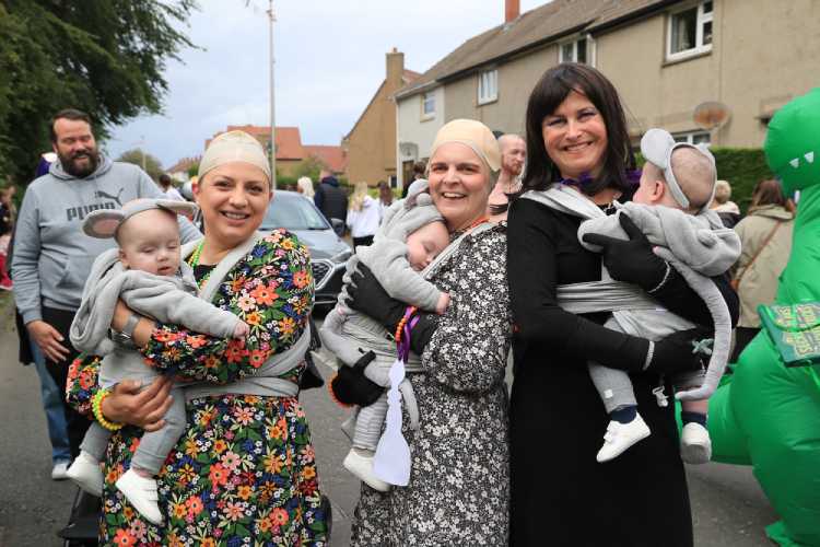 AK0I0198 Six Month old baby triplets in Parade