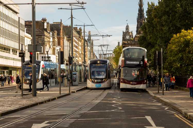 Bus and tram travel along Princes Street - a Getty image