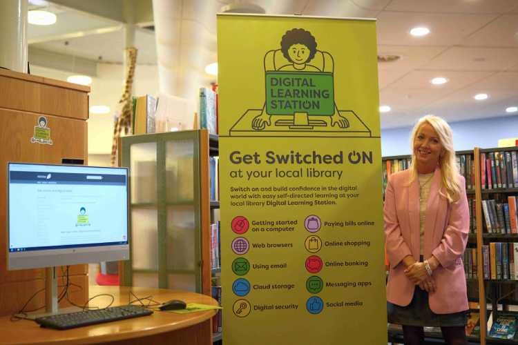 Cllr Kelly Parry beside a Digital Learning Station at Penicuik Library