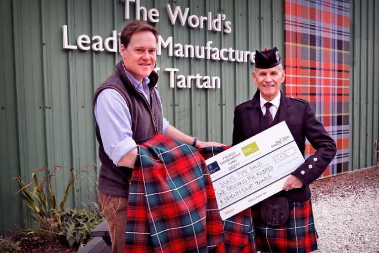 Representing the Fallago Environment Fund, His Grace The Duke of Roxburghe joins Andrew Ainslie, Pipe Major, Duns Pipe Band to collect a new bale of the band’s tartan from Lochcarron of Scotland in Selkirk. Image - Paul Dodds