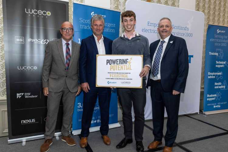 Val Chisholm and apprentice Reece Michie of V C Electrical receive the funding from Luceco's Ian Hunter and Darren Crockett