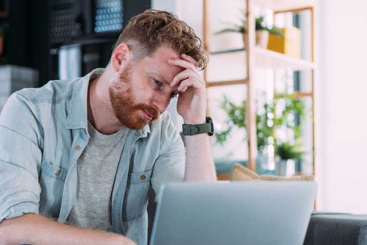 A person using a laptop at home. The image illustrates the importance of being alert to phishing attempts and scams that impersonate HMRC.